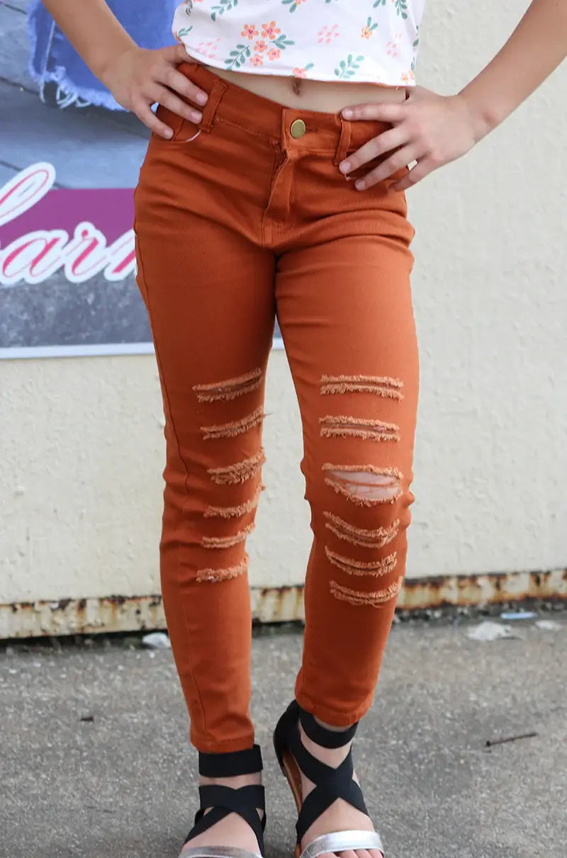 RUST RIPPED SKINNY JEANS. Youth